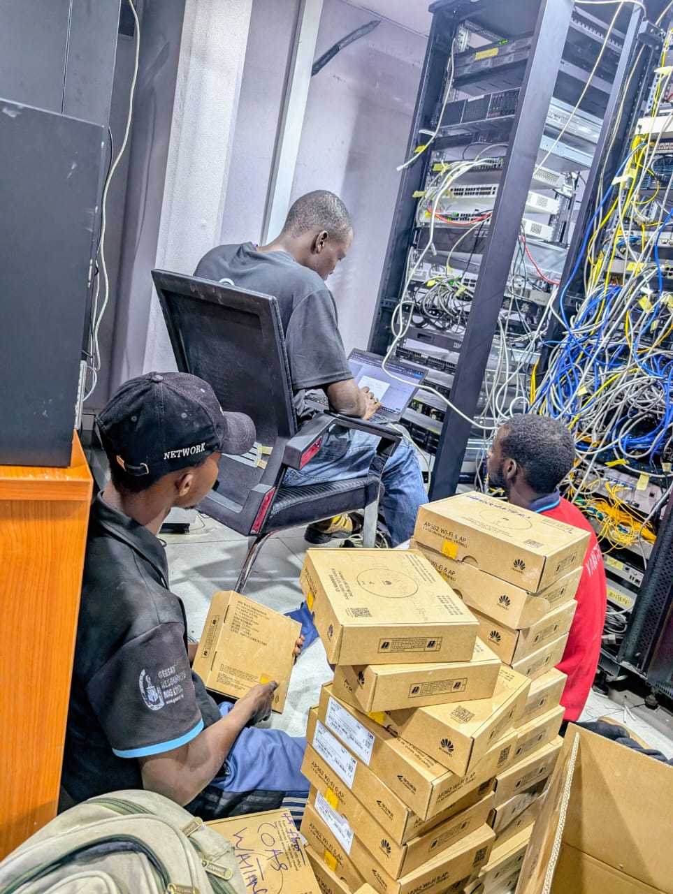 YAROTECH fiber and wireless installation team working in network rack room